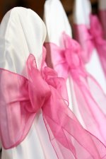 hot-pink-wedding-chair-bows-white-chair-covers.jpg
